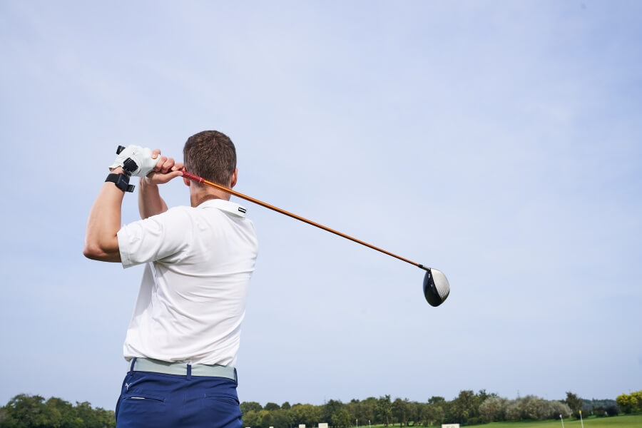 golfer finished shot with driver