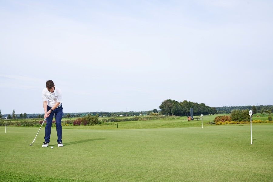 golfer on putting green training by wearing HackMotion