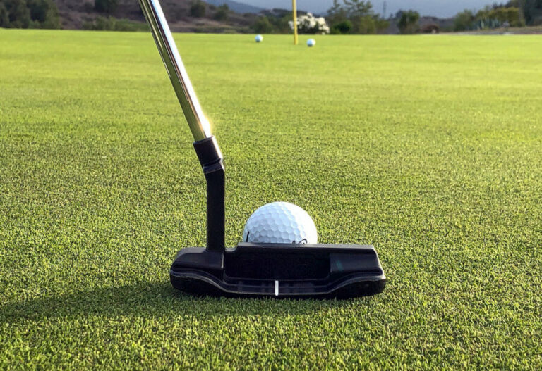 putting a golf ball on green